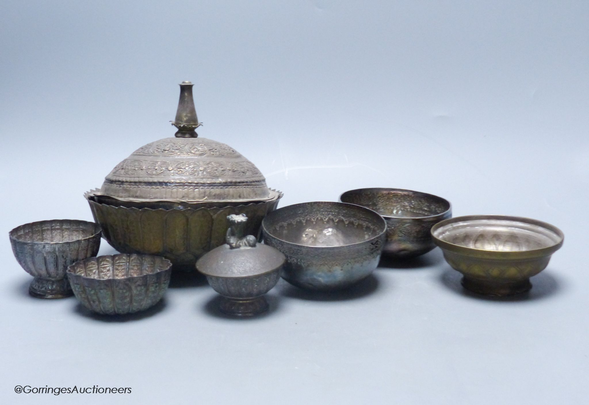 A Malay Straits pedestal bowl and cover or 'Batil Ber Tutop' (a.f.), three Malay Straits white metal betel nut cups and two similar small bowls